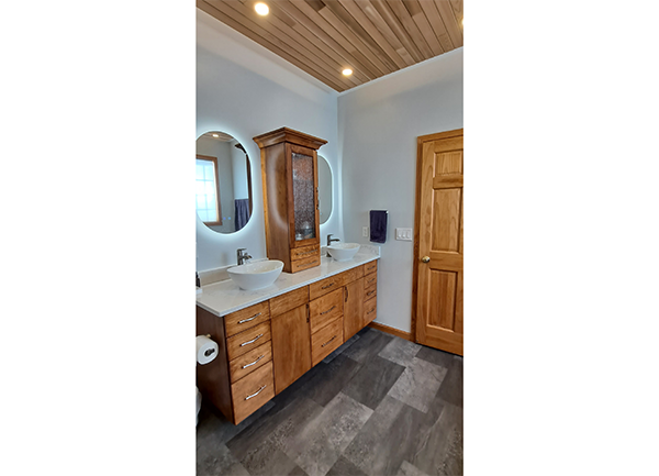 bathroom showing sinks & cabinets & wood ceiling photo