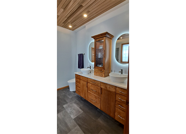 residential bathroom with cabinets & sinks photo